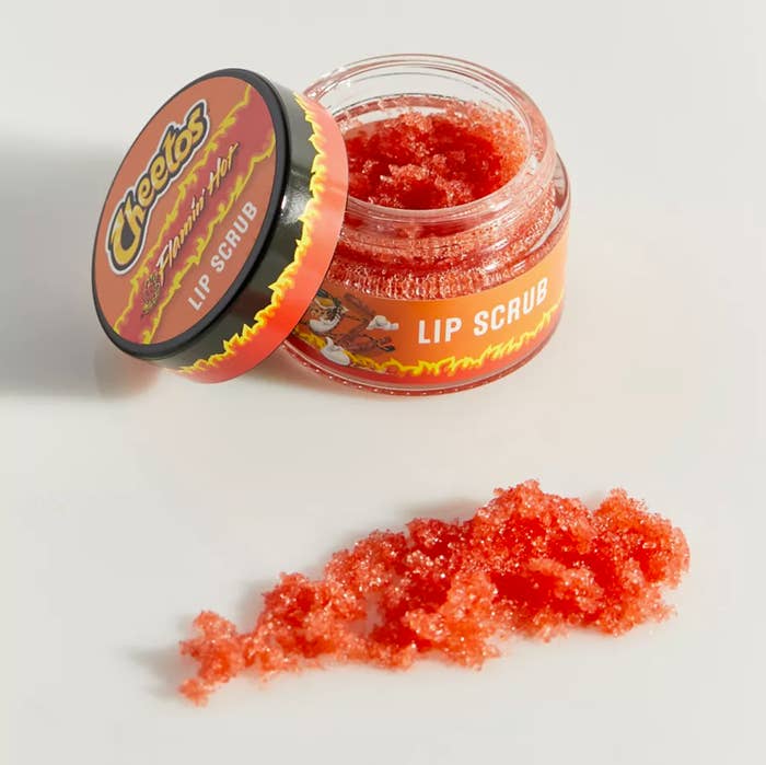The tub of lip scrub with a swatch in front of it