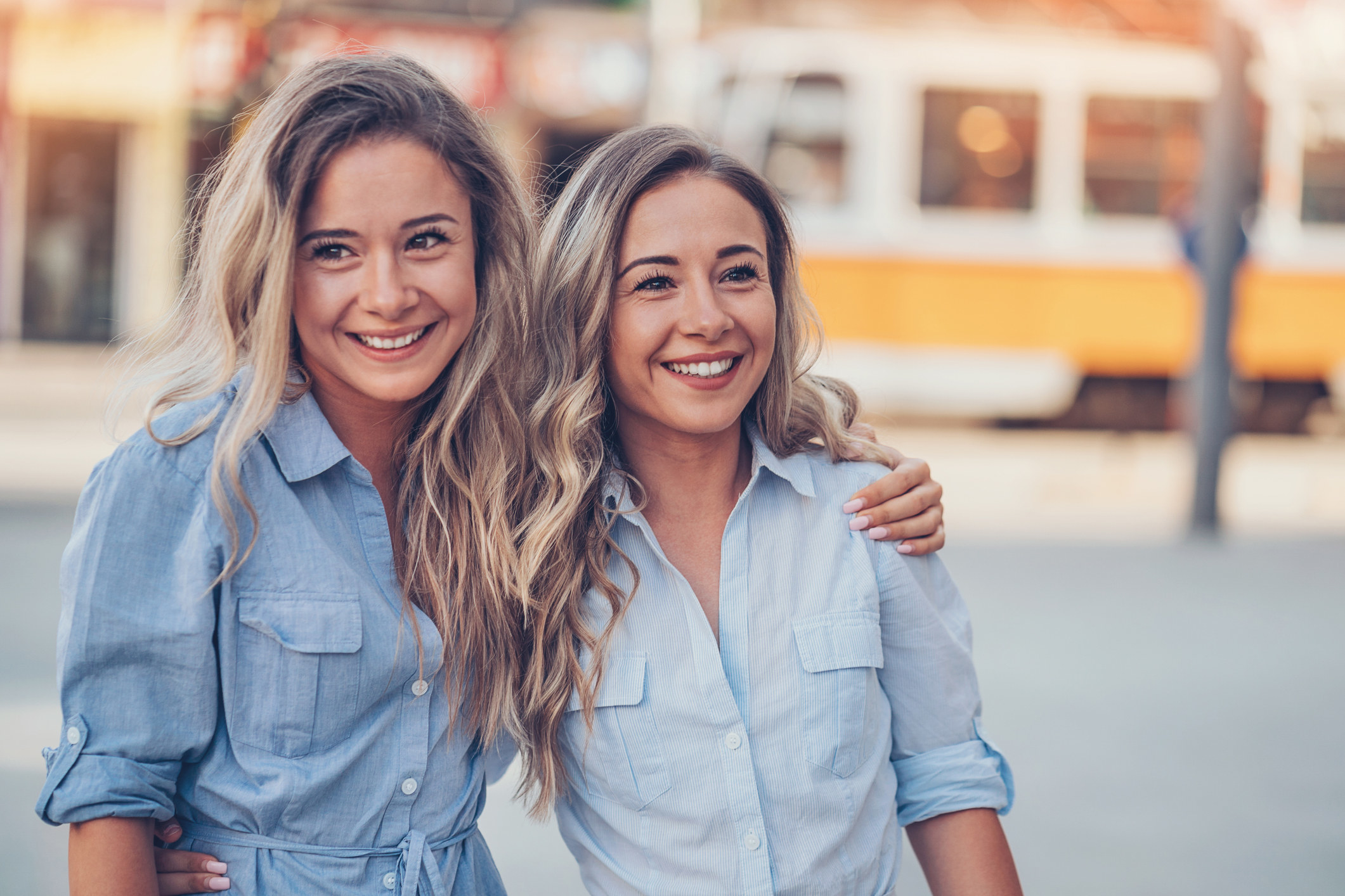 Sisters smiling and holding each other