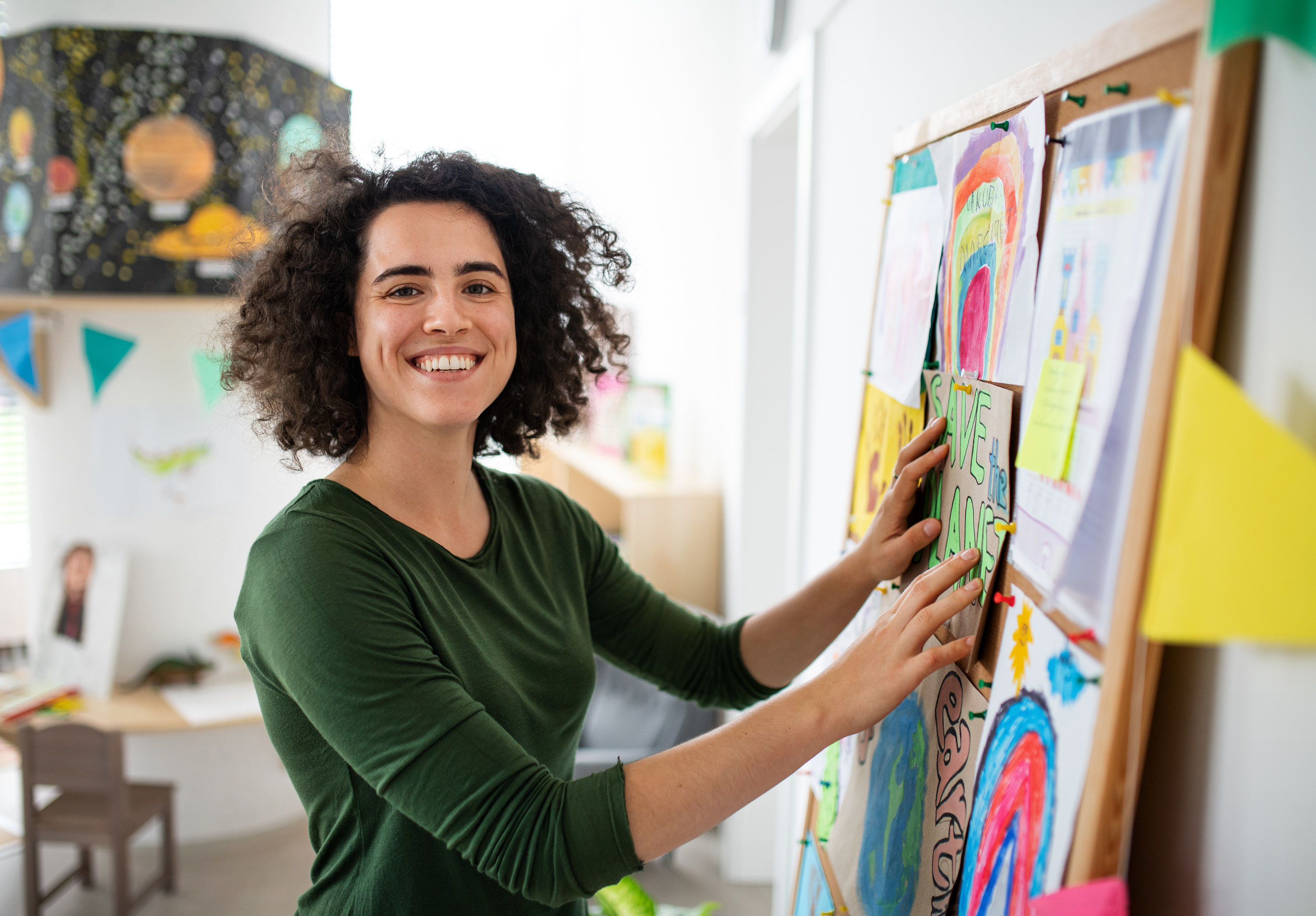 a person putting something on a corkboard