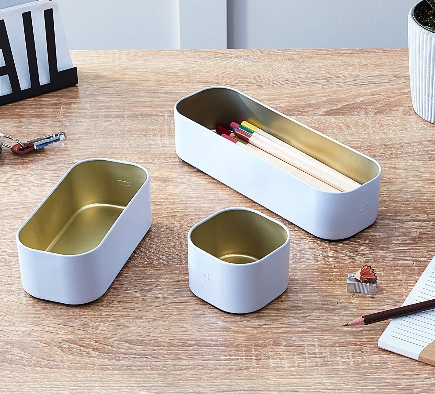 a trio of powder coated metal storage containers on a desk