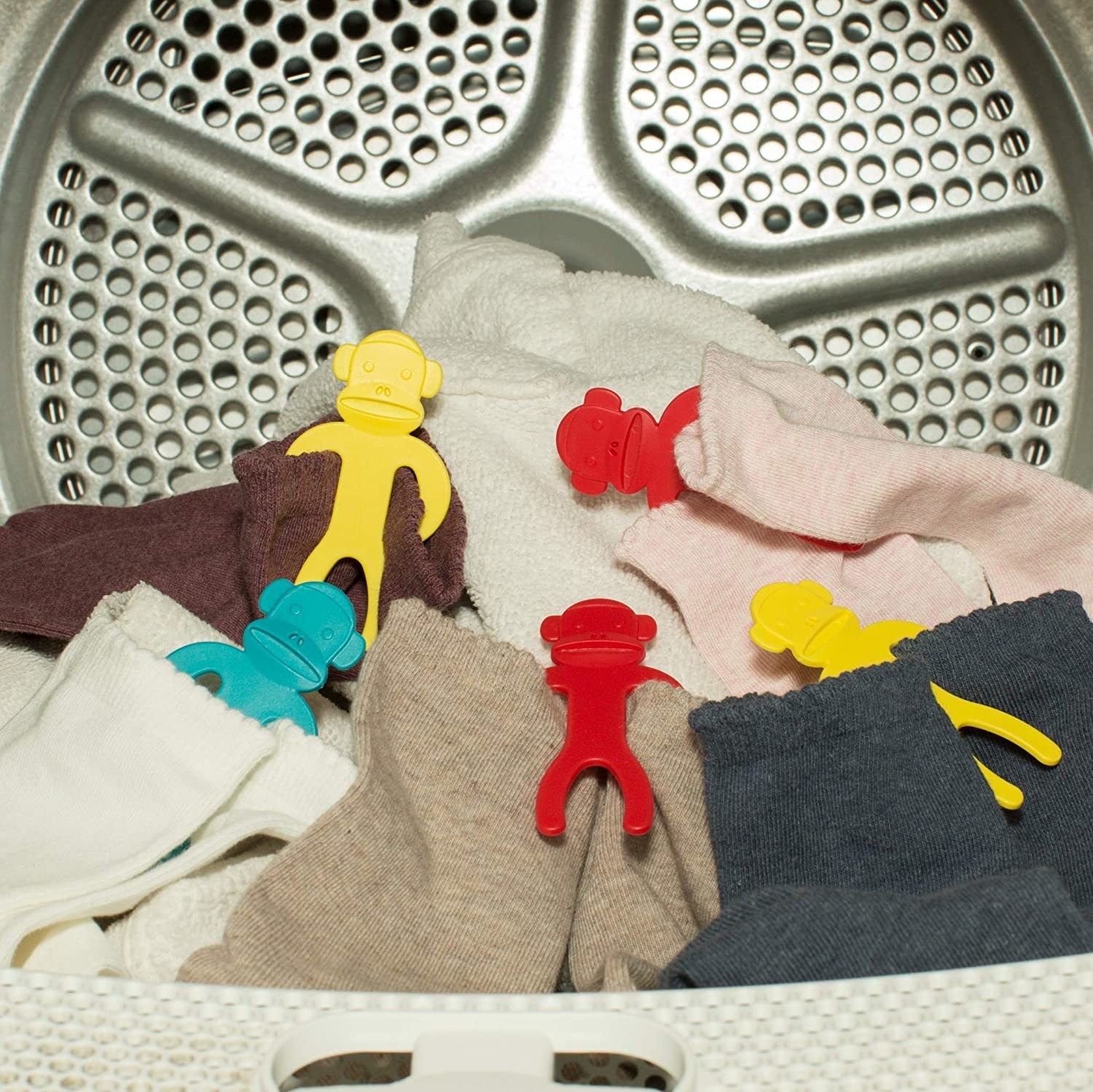 Several sock monkeys in a dryer