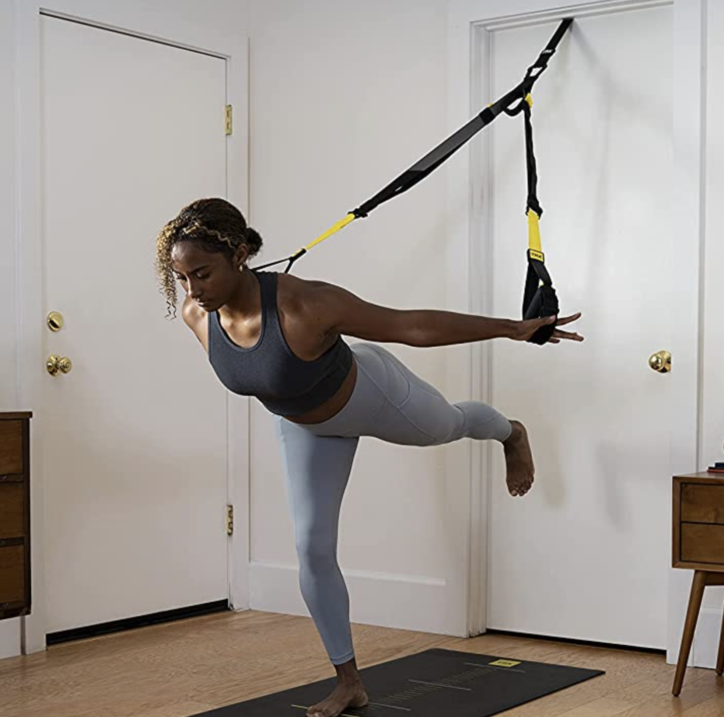 a person working out with the TRX system in a bedroom