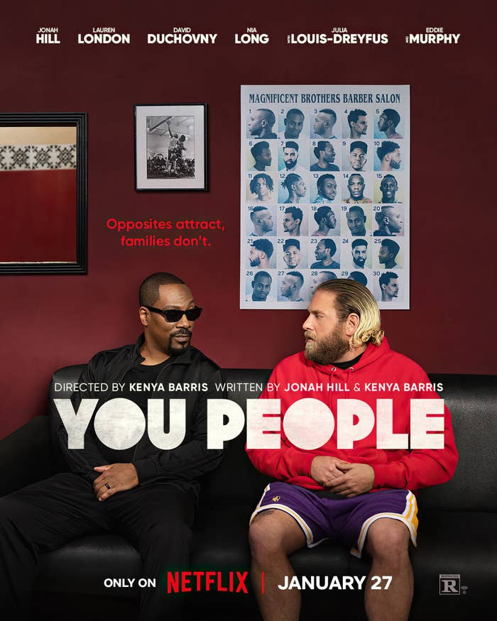 A promo poster for &#x27;You People&#x27; that shows Eddie Murphy and Jonah Hill looking at each other while sitting on a couch in a barber shop. Eddie is wearing shades