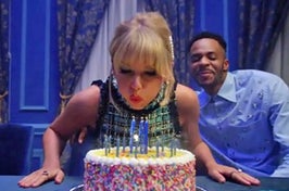 Taylor Swift blowing out candles on a birthday cake in the Lover music video