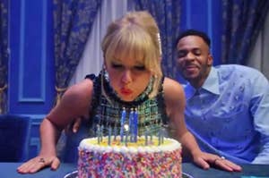 Taylor Swift blowing out candles on a birthday cake in the Lover music video