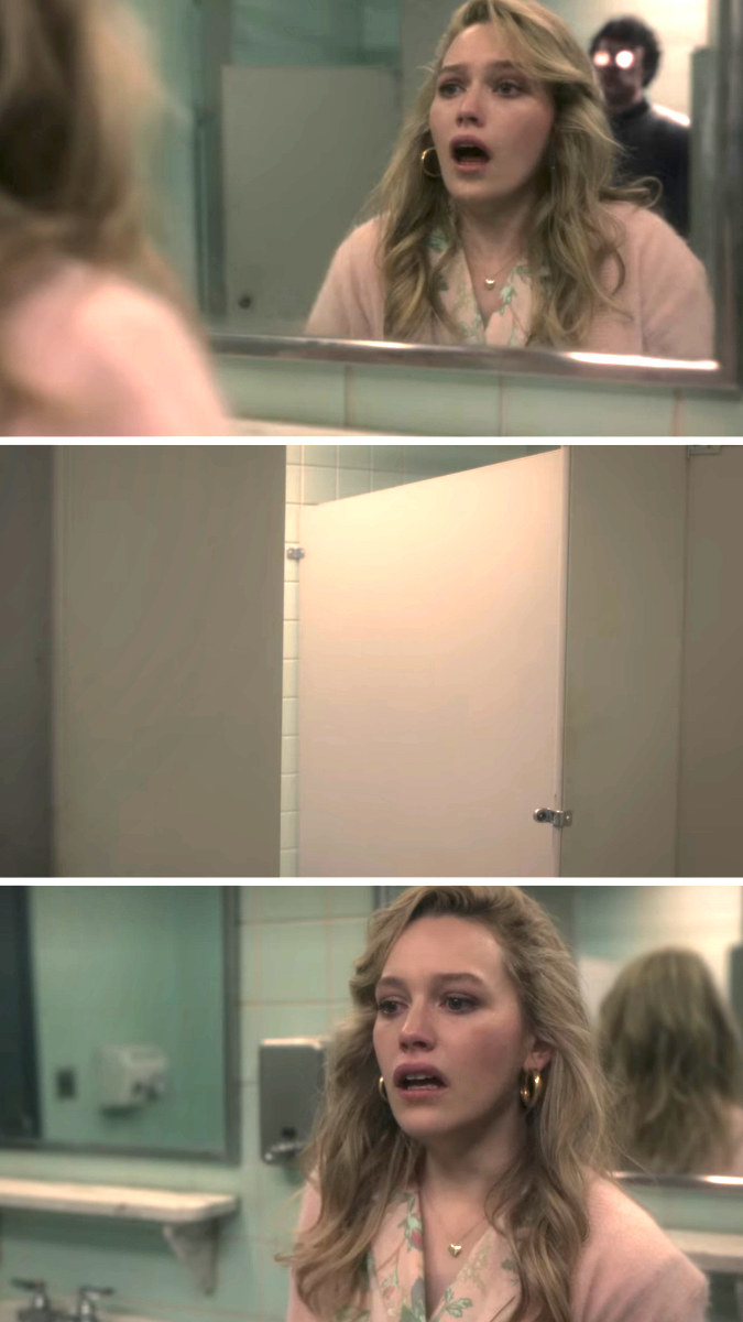 A woman seeing someone behind her in the bathroom