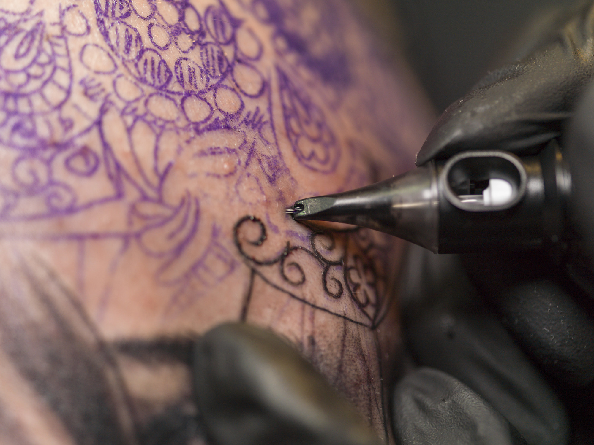 Closeup of a tattoo artist tattooing
