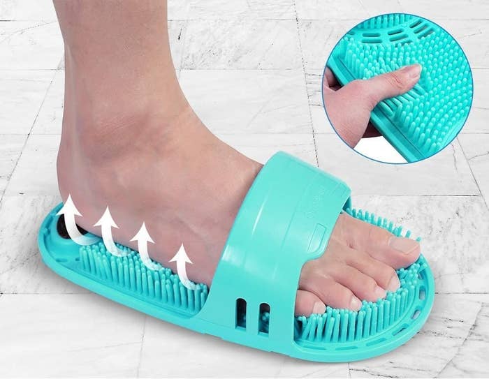 a person scrubbing their foot using the slip-on scrubber