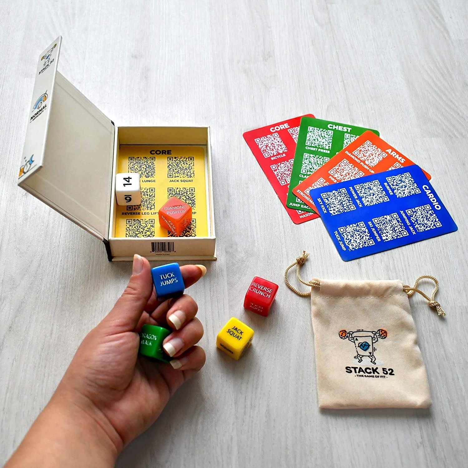 a person holding a few of the dice over the box