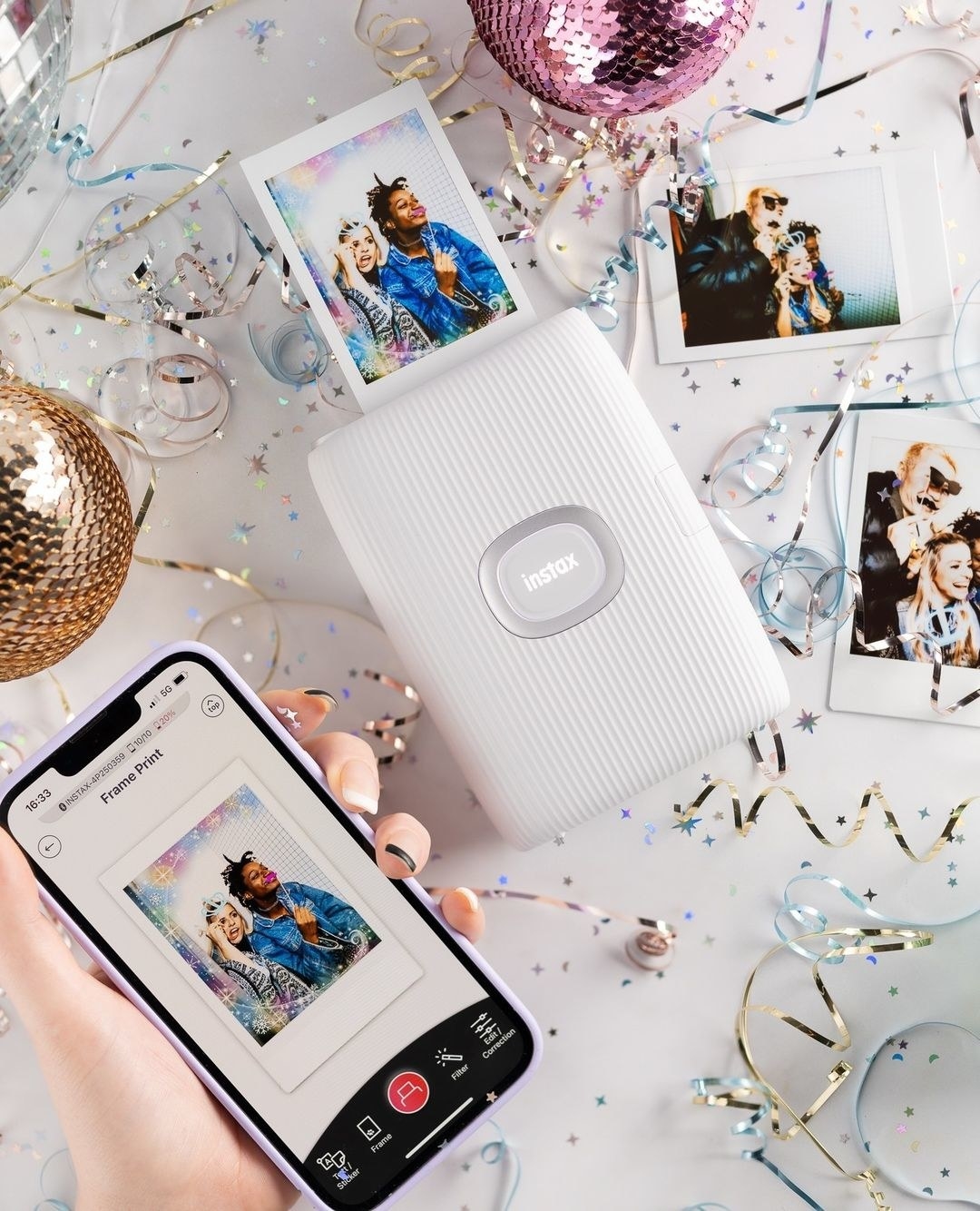 a person printing photos on the instax right from their phone