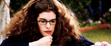 mia in the princess diaries blowing hair out of her face