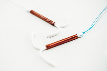 An image of two copper IUDs.