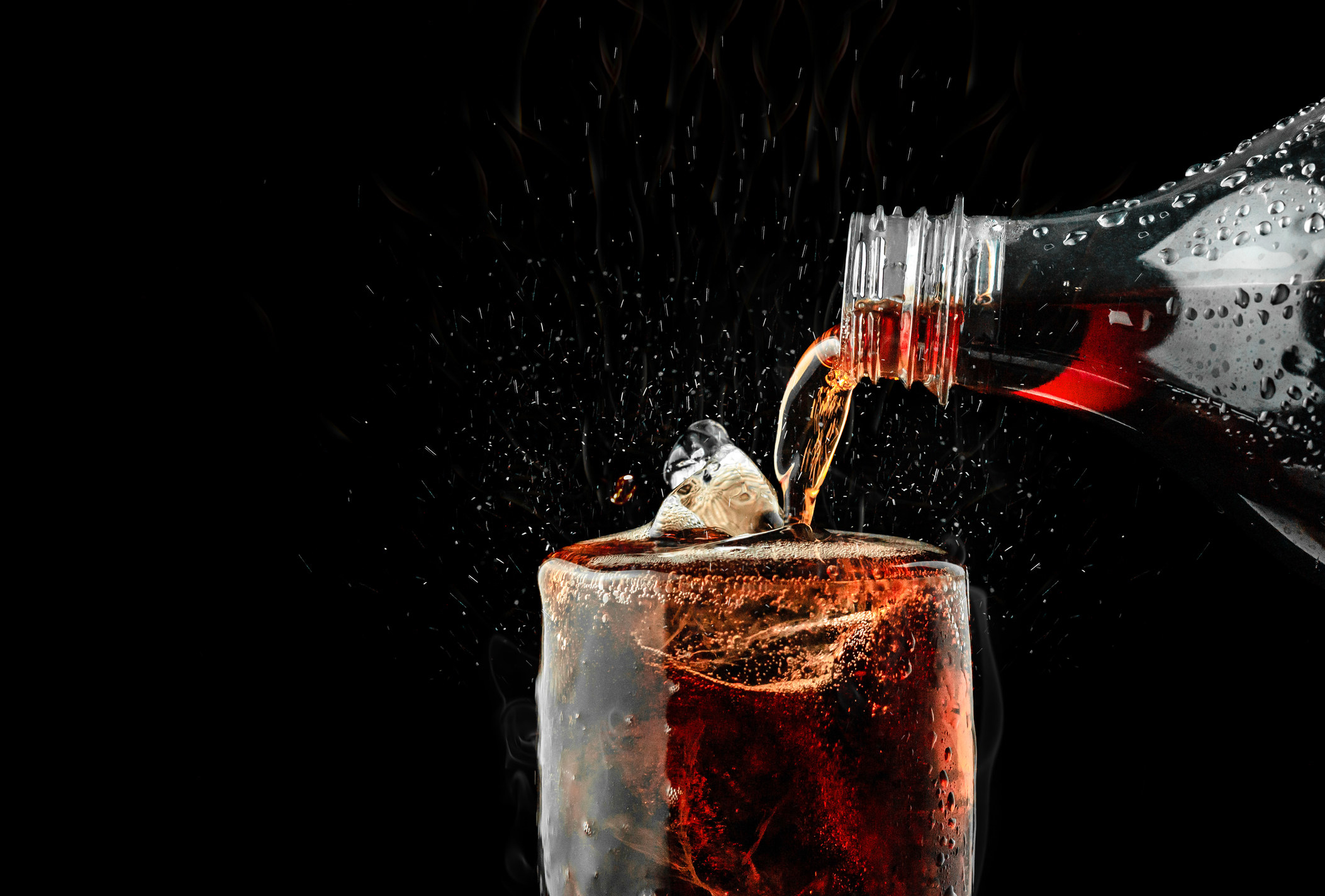 coke being poured into a glass