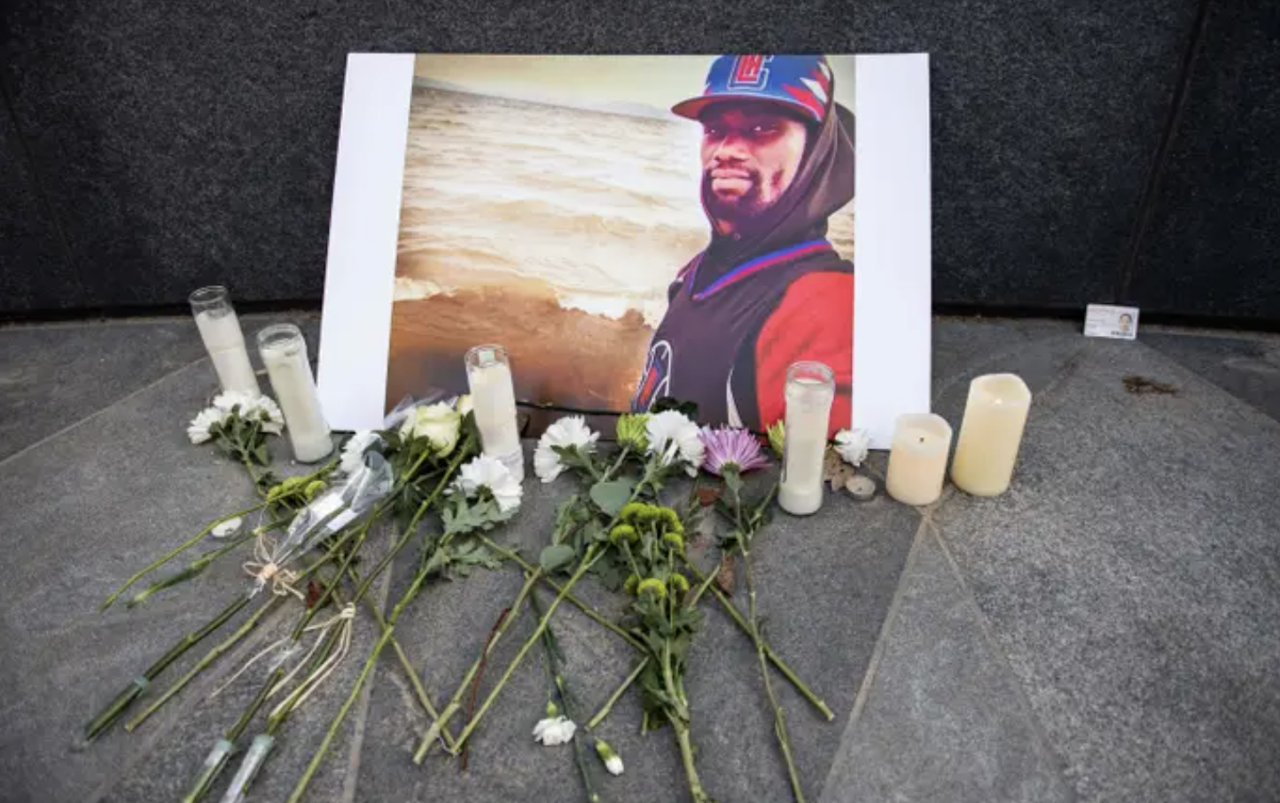 a memorial with candles and flowers and a photo of tyre nichols