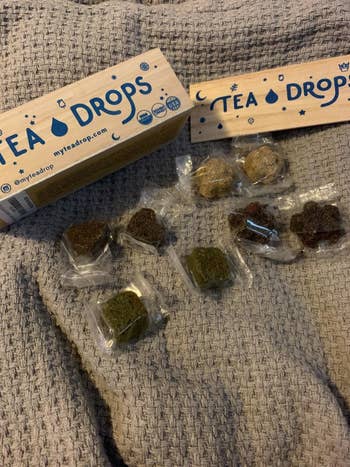 A reviewer's open box of Tea Drops with the individually packaged drops out of the box