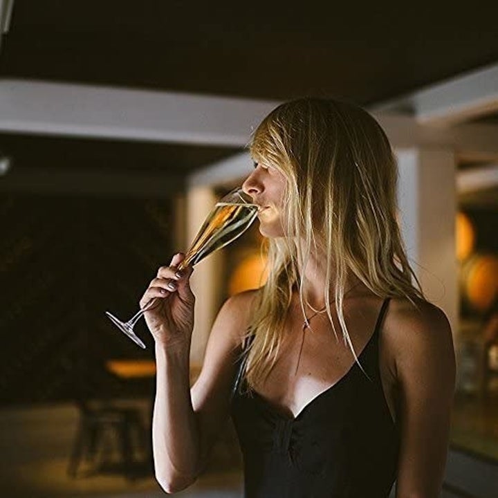 A model drinking from the champagne flute