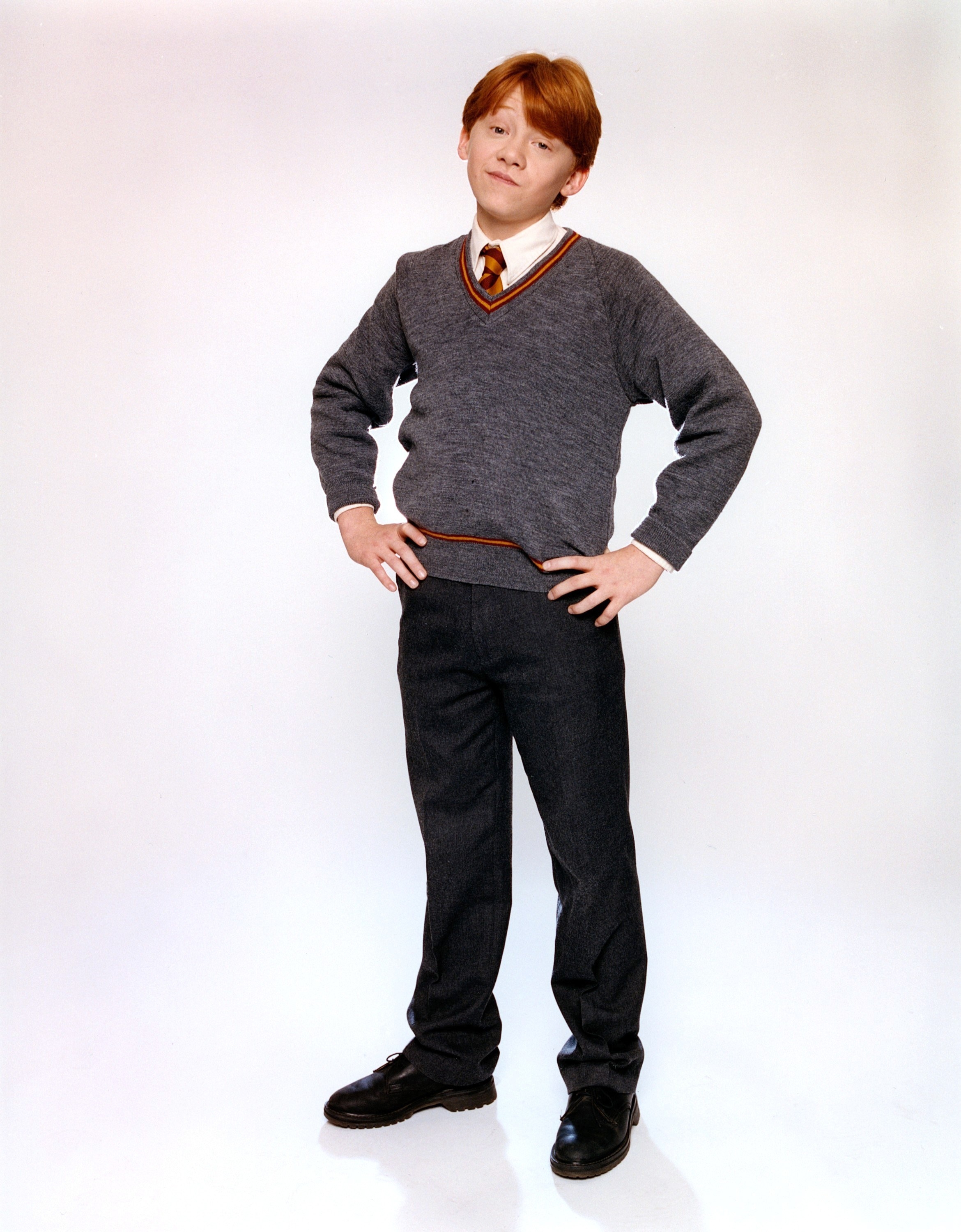 A promo shot of Rupert as Ron Weasley in school uniform. Ron has his hands on his hips