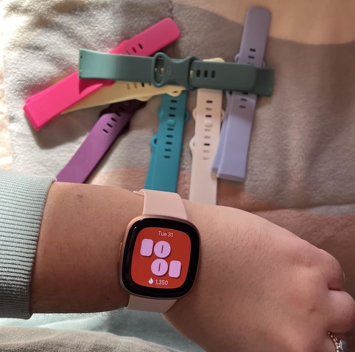 Bianca showing off the watch with different bands in the background