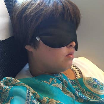 A reviewer wearing the eye mask to sleep