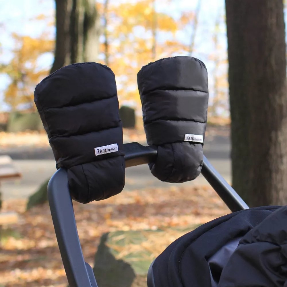 Black mitten-like gloves attached to stroller handle