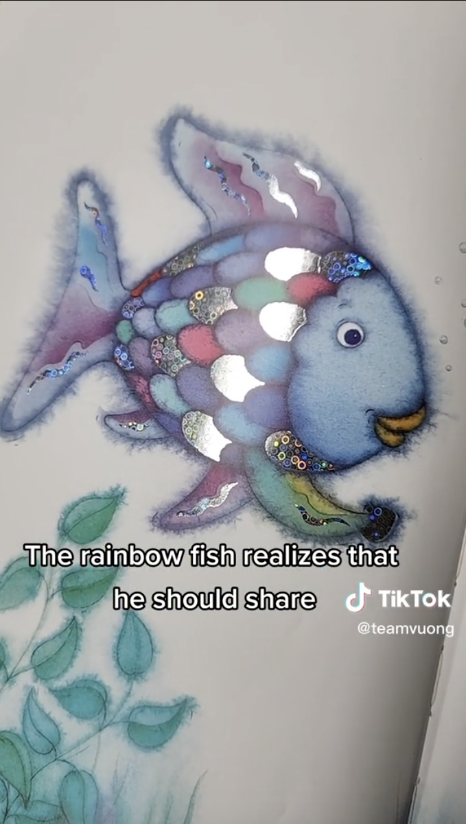 Screenshot of TikTok from user @teamvuong of a page in the book Rainbow Fish of a fish holding a scale