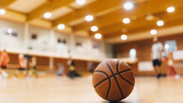 An assistant basketball coach has been fired after allegedly posing as a 13-year-old player while said player was out of town for another tournament.