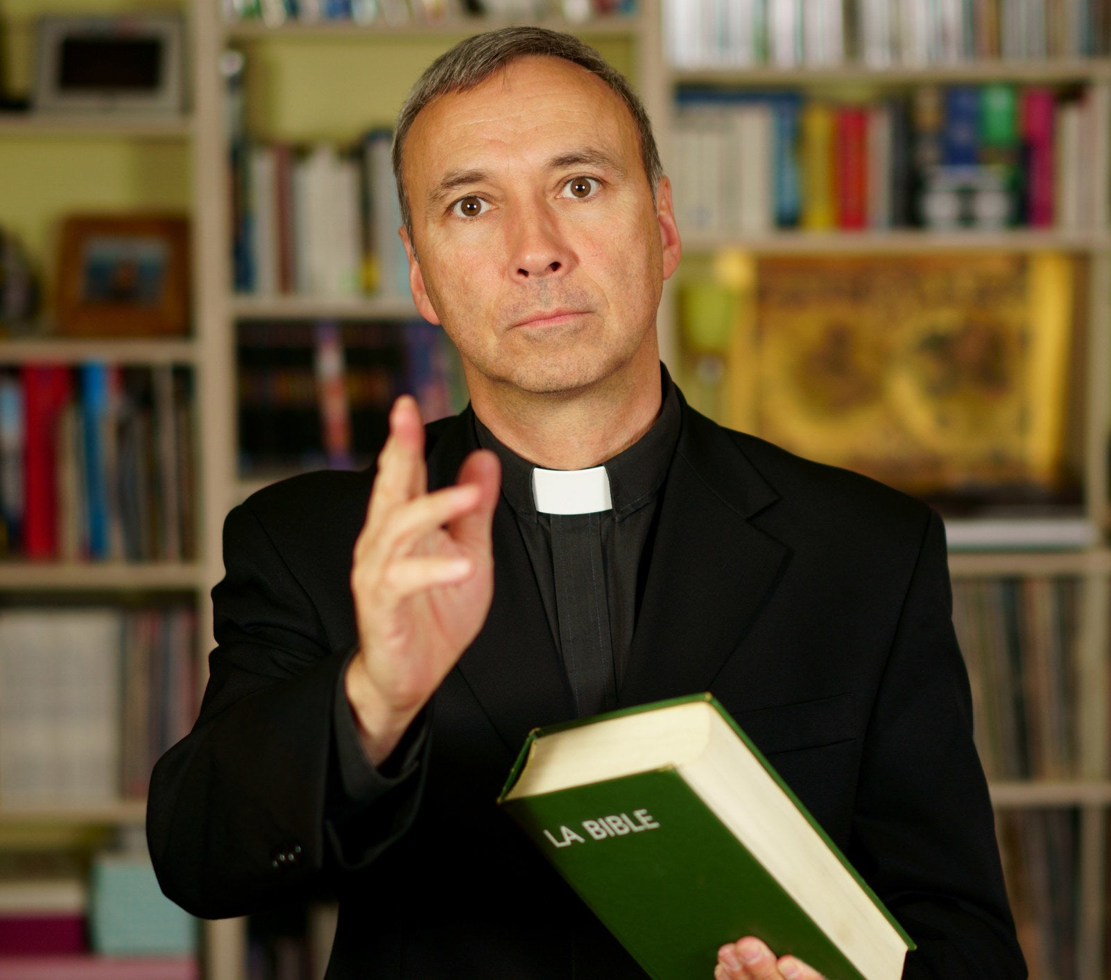 priest holding a bible