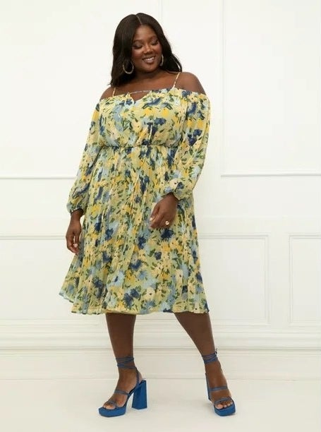 Model wearing a yellow and blue dress with blue shoes