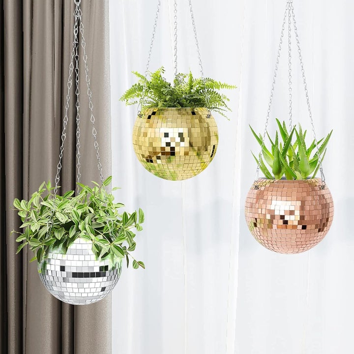 Three hanging disco planters, one gold, one silver, and one rose gold