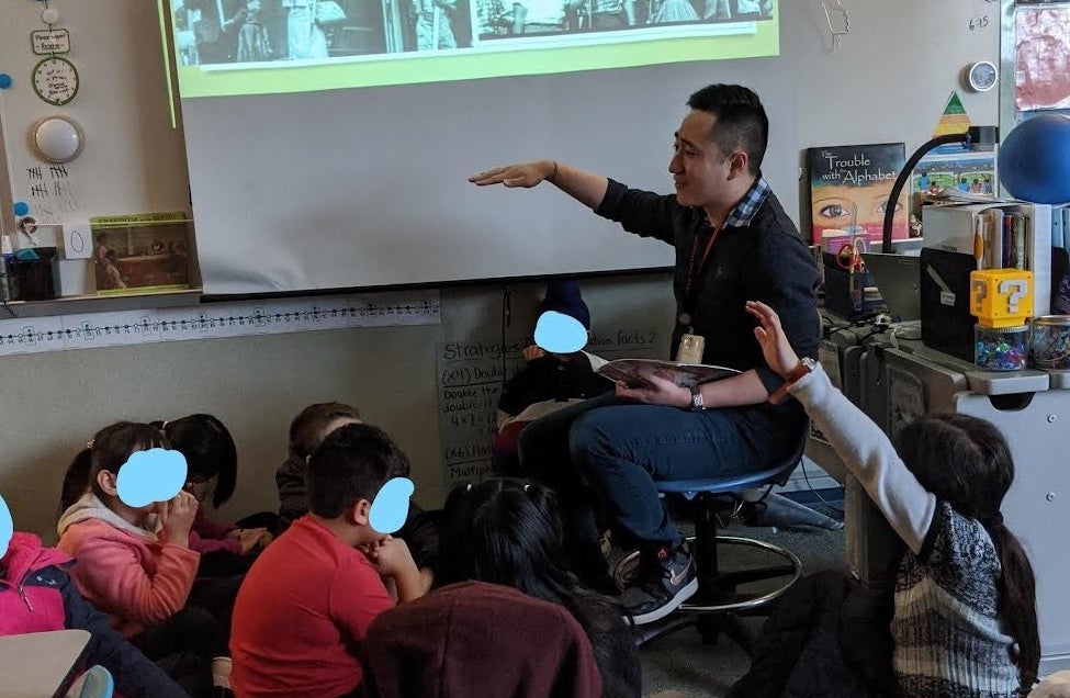 Mr. Vuong teaching a classroom of children