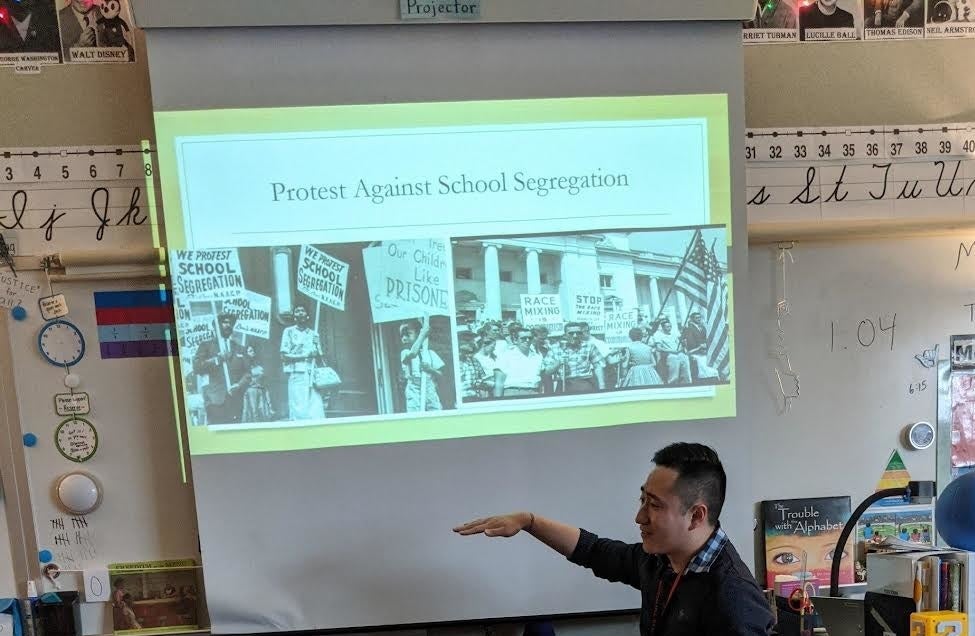 Mr. Vuong teaching a classroom of children