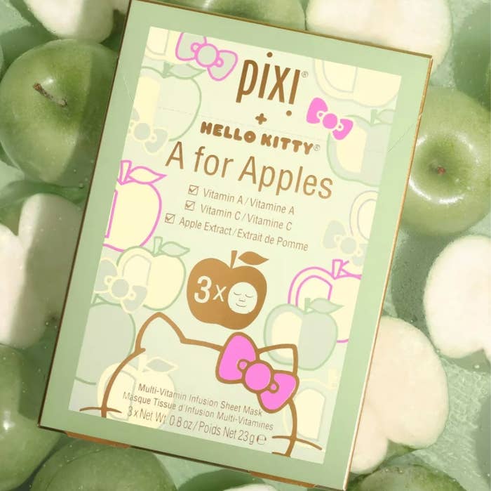 the green box of sheet masks on top of sliced green apples