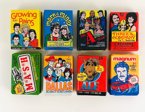 A collection of waxed covered trading cards from various 80s TV shows