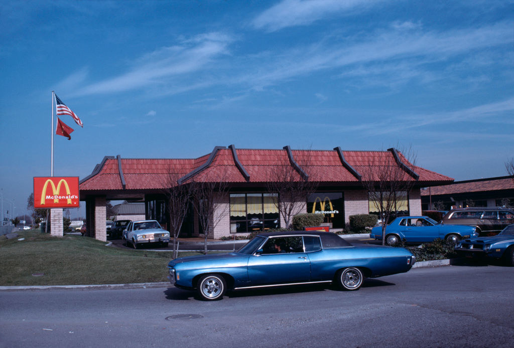 McDonald&#x27;s from the early 80s with cars in line for drive thru