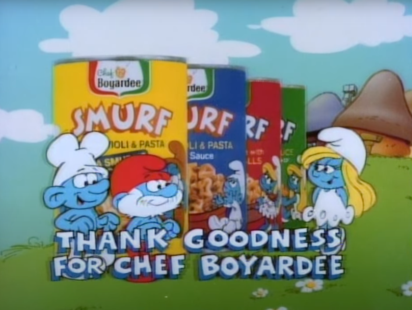 Screen shot of the commercial of the Chef, Papa Smurf, and Smurfette standing in front of Smurf pasta cans