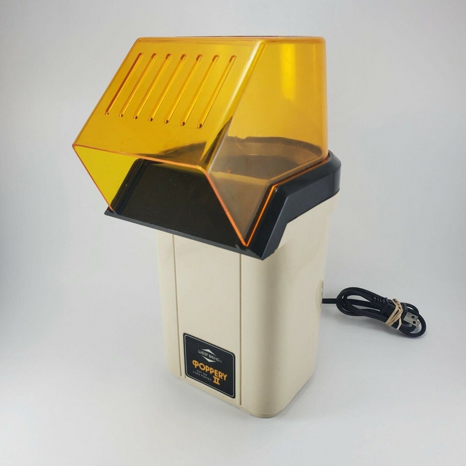 Air popcorn popper with a clear yellow spout