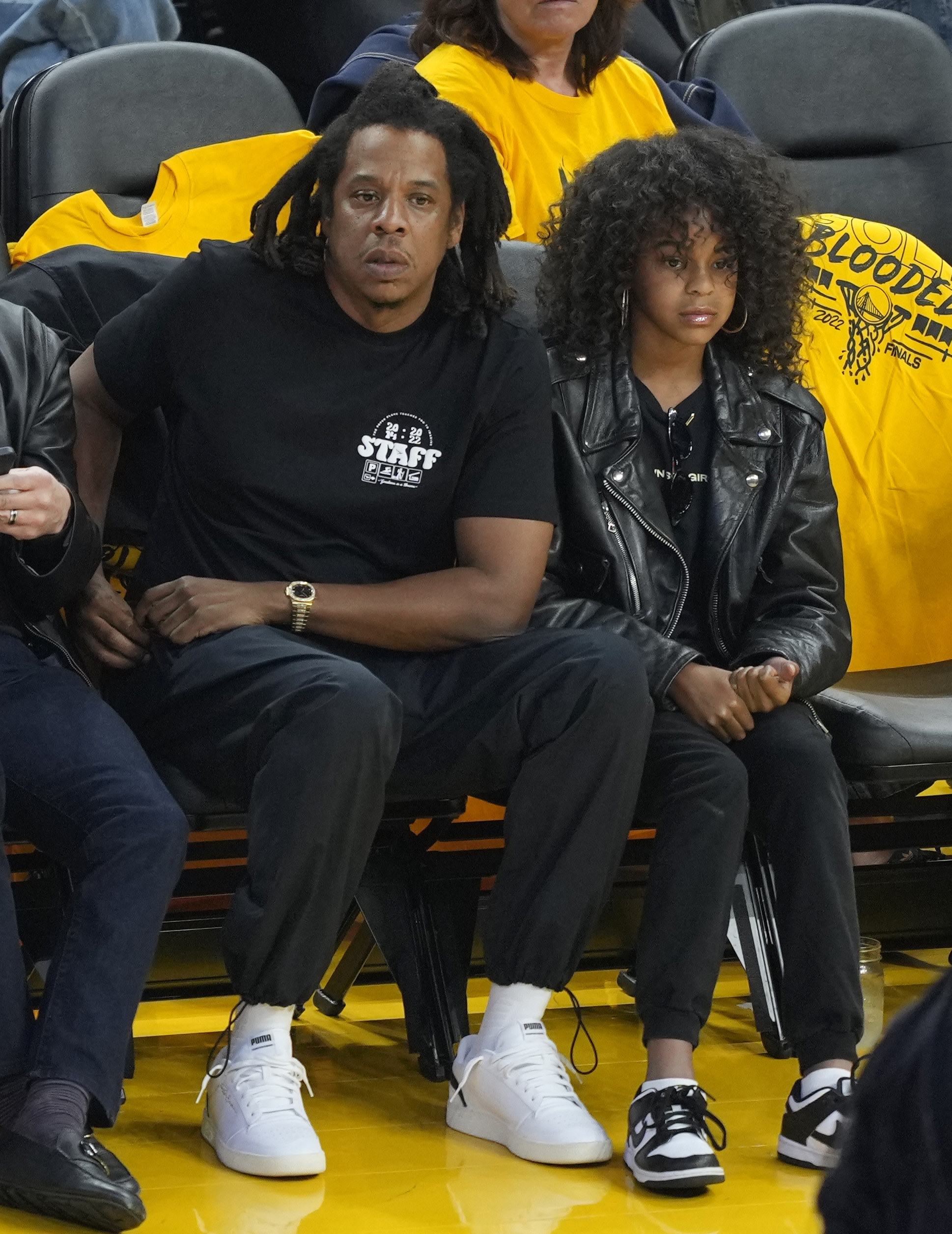 Jay Z and Blue Ivy at a basketball game sitting courtside