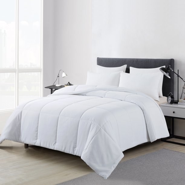 white down alternative comforter on a gray upholstered bed