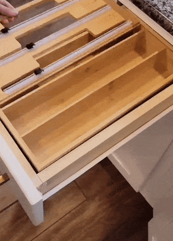 gif of person installing plastic wrap, wax paper, and aluminum foil in the organizer