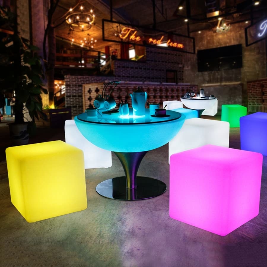 a set of light-up cube chairs arranged around a patio table