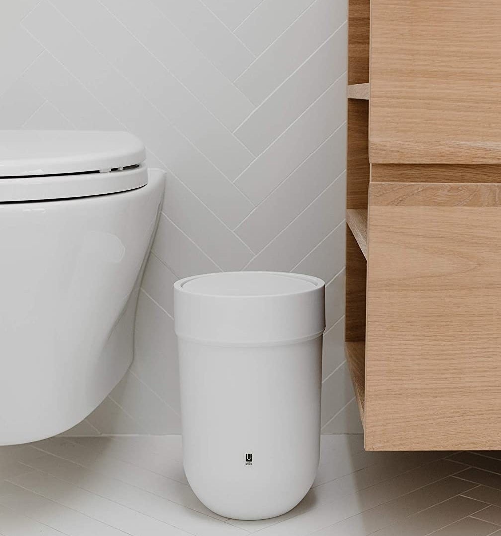 a sleek trashcan in a bathroom