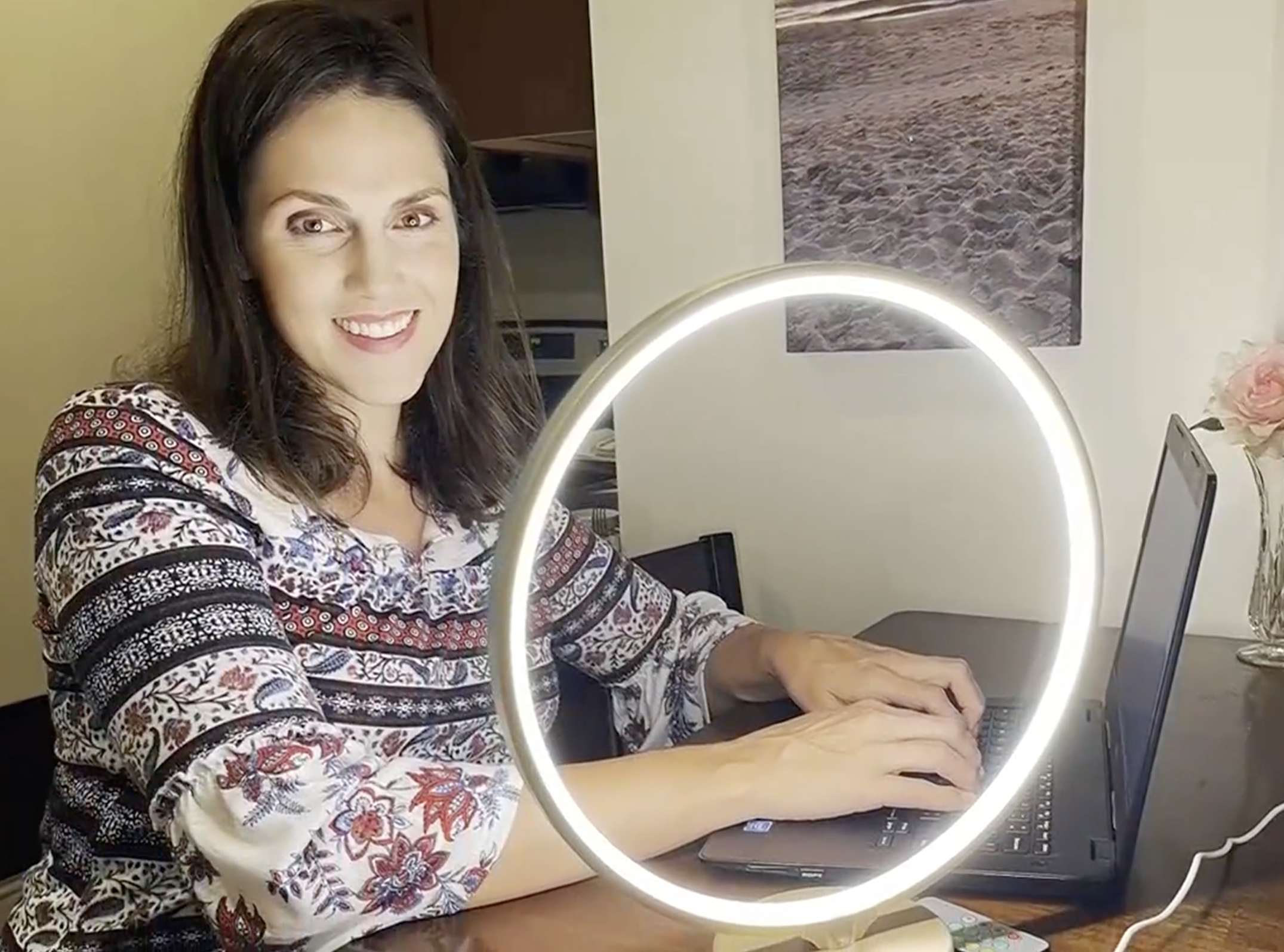 person on their computer with the lamp next to them