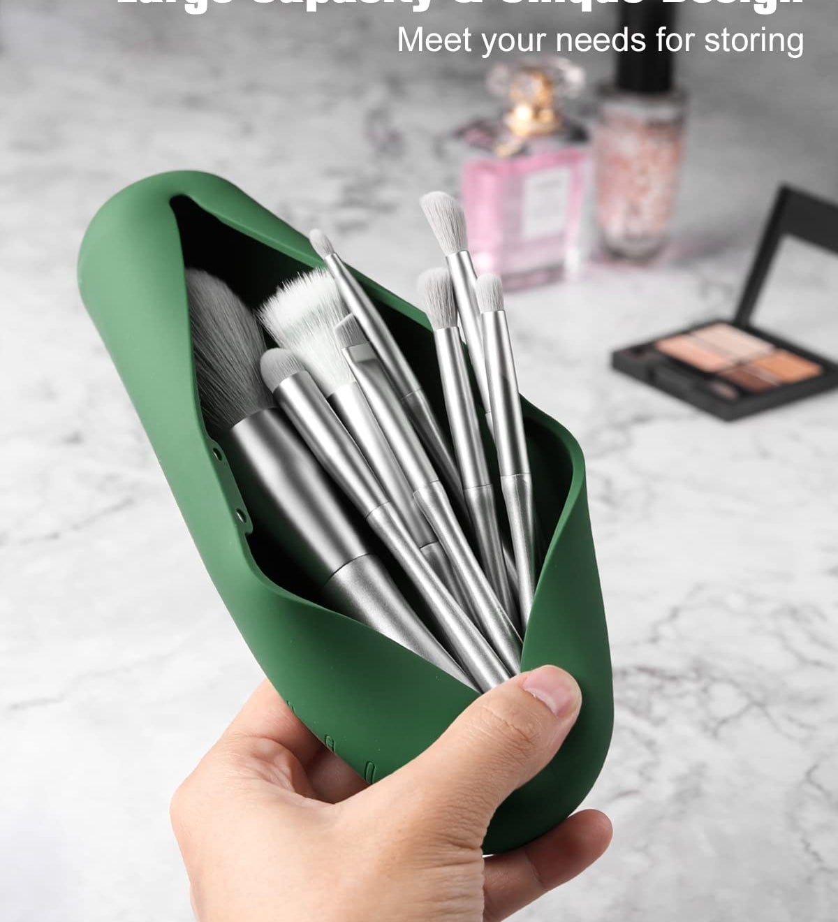 a person popping open the magnetic closure on the silicone pouch