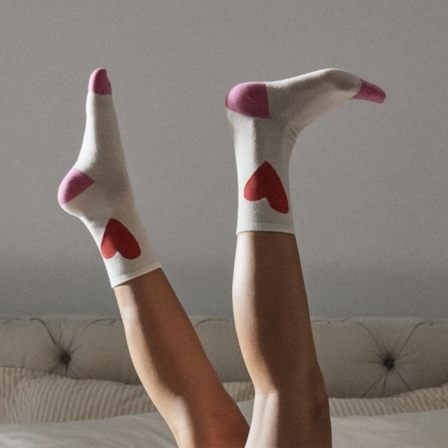 A person wearing the socks and kicking their feet up