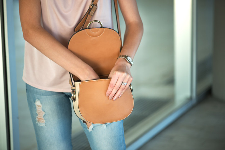 A woman reaching into her purse