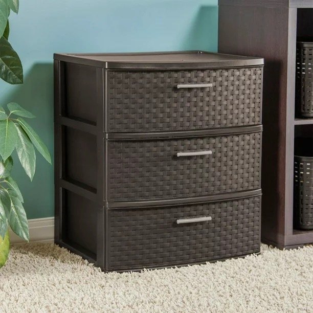 an espresso brown three-piece drawer on a bedroom carpet