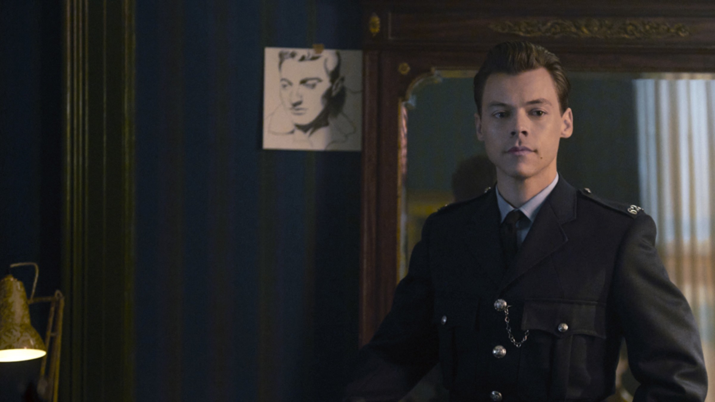 Harry wearing a police officer&#x27;s uniform as she stands inside a house in a scene from My Policeman