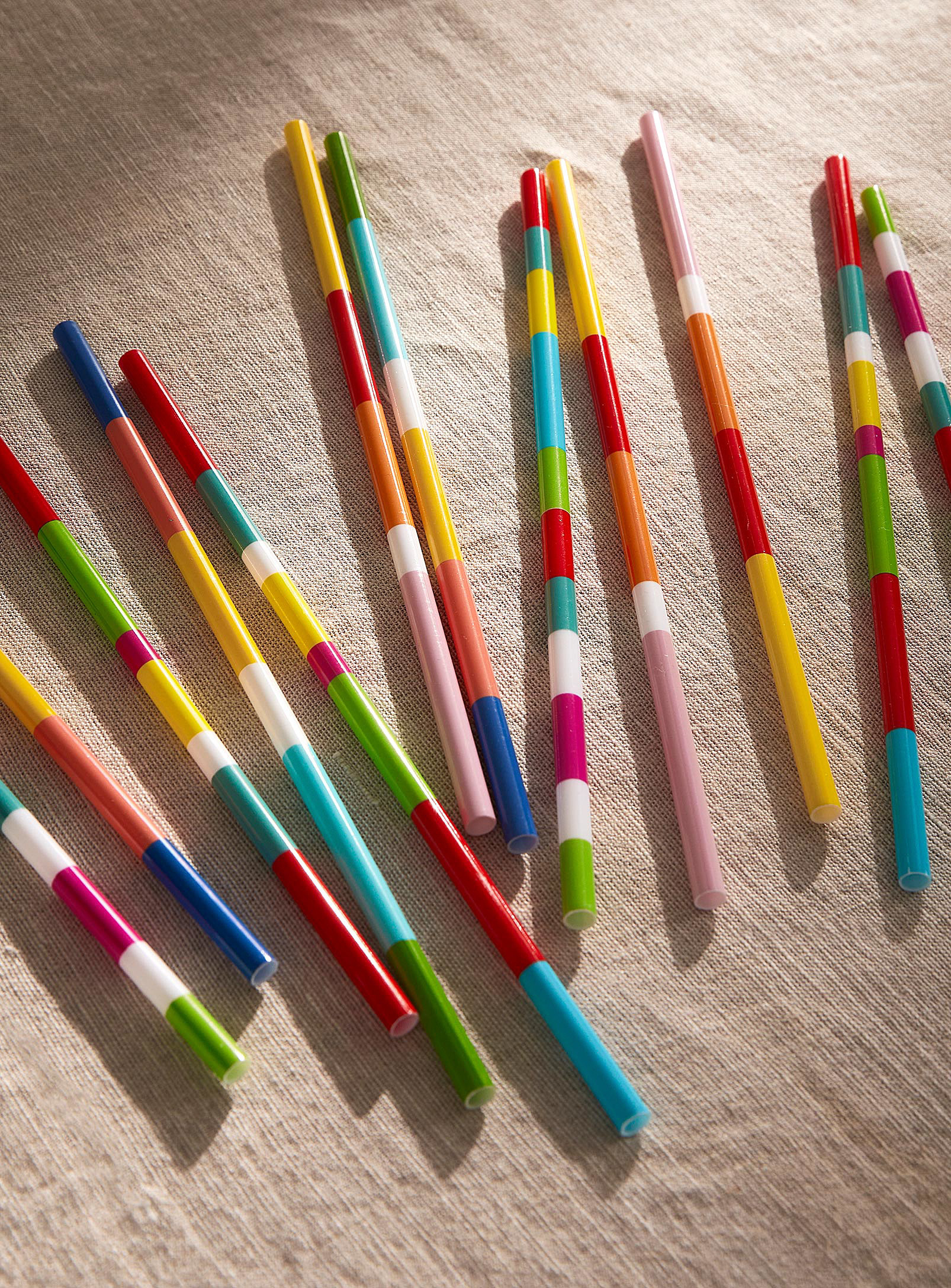 Several straws laid out on a tablecloth