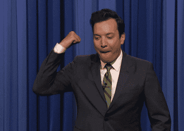 Jimmy Fallon fist bumping with one arm