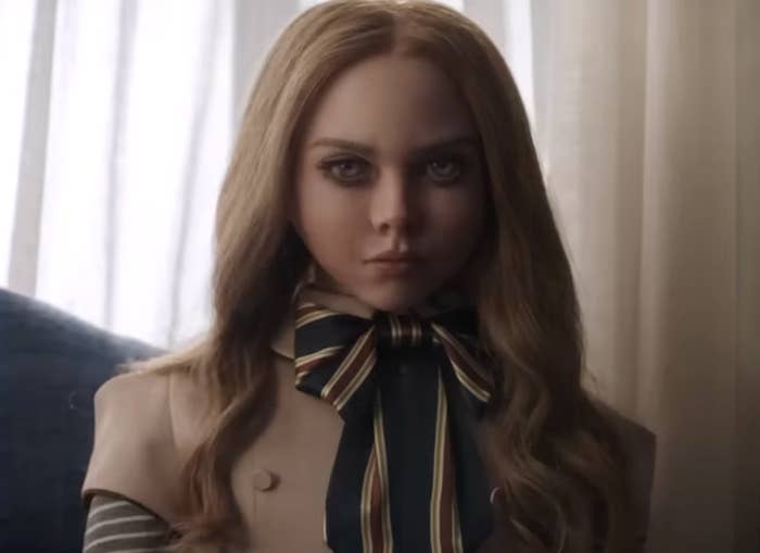 Megan, the doll, with long blonde hair, a nice dress, with a bow, looking angry